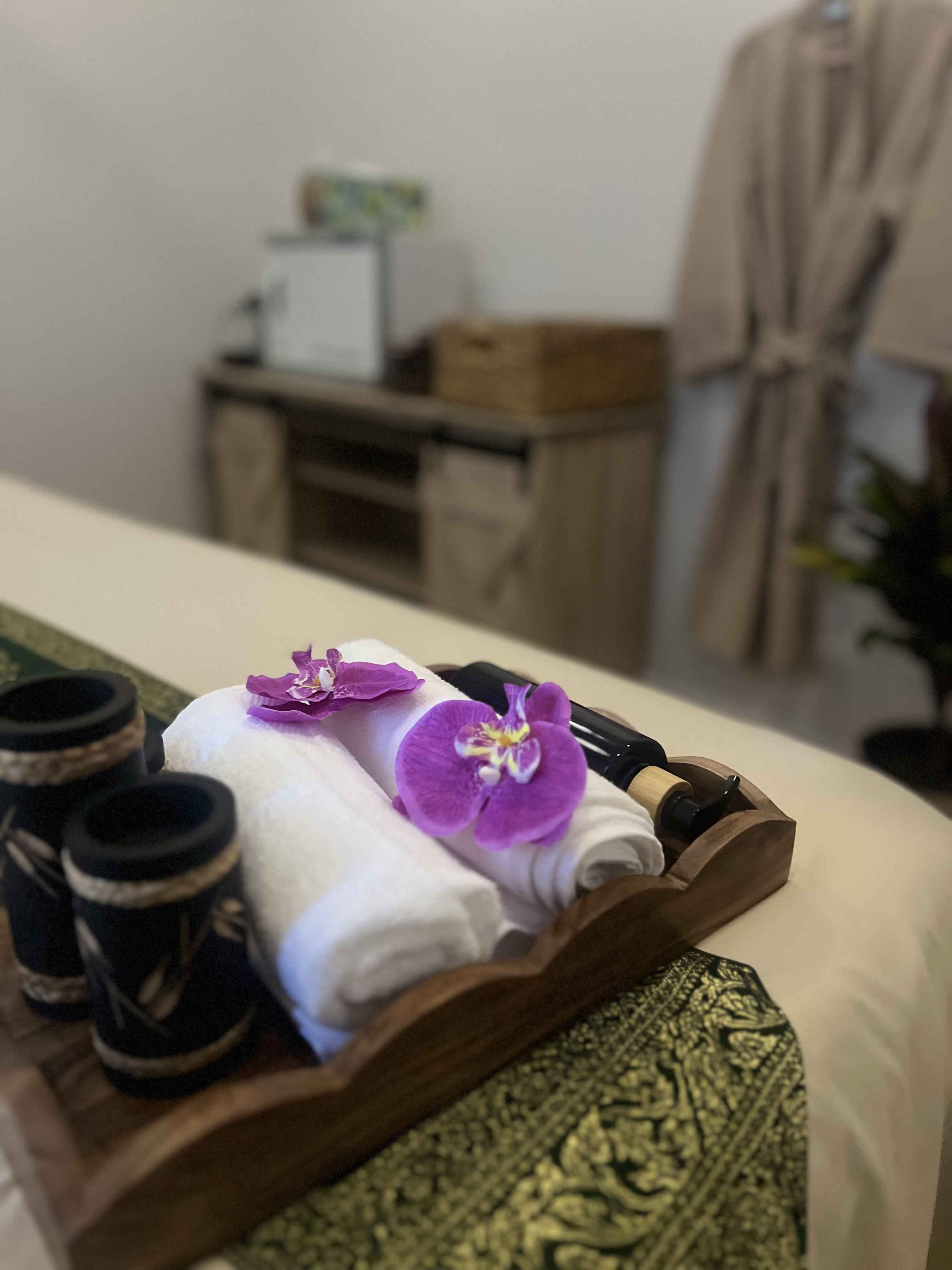 Janjao Thai Spa treatment room prepared with fresh towels and orchids